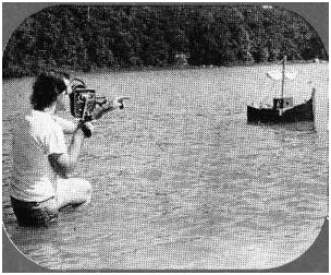 A cameraman films one of the model ships for a mock battle scene in the parody remake of Ben Hur.